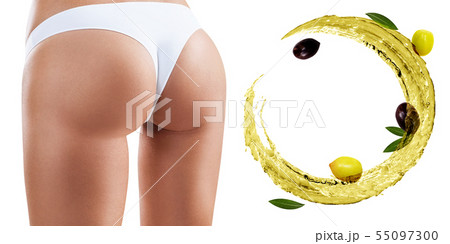 Female buttocks near swirl olive oil. Dieting concept. 55097300