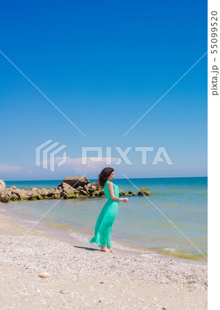 Young girl on summer beach with shell Young girl on summer beach with shell 55099520