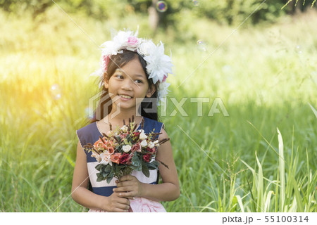 Smiling girl with happy face relaxation in garden. 55100314