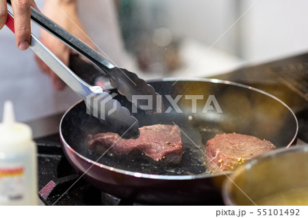 Fry the meat in a frying pan. Chef preparing and 55101492