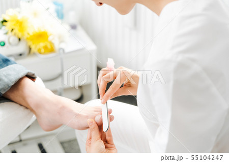 Podiatrist working on men's feet 55104247