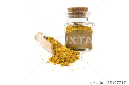 yellow curry in wooden scoop and jar on isolated yellow curry in wooden scoop and jar on isolated 55107717