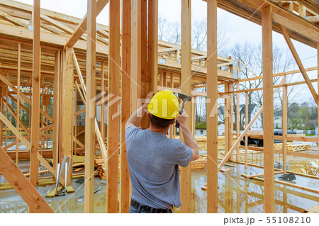 Construction crew working on the roof sheeting of Construction crew working on the roof sheeting of 55108210