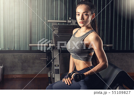 Beautiful fitness Asian woman with a towel after g Beautiful fitness Asian woman with a towel after g 55109827
