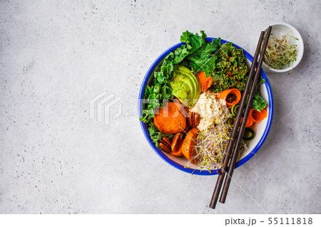 Healthy vegan lunch in white bowl. Buddha bowl 55111818