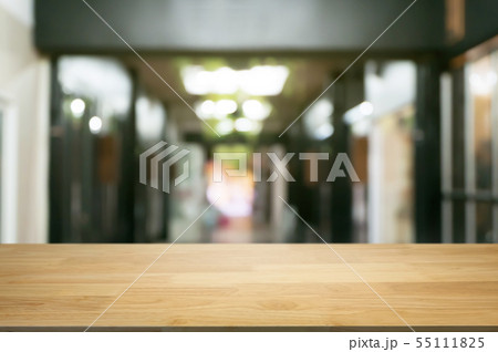 empty wooden desk over blurred coffee shop empty wooden desk over blurred coffee shop 55111825