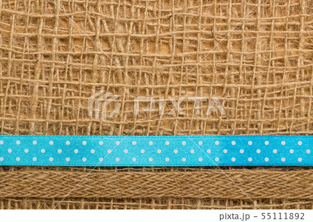 Dotted ribbon on burlap cloth background 55111892