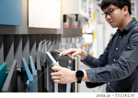 Asian man choosing cabinet or countertop materials 55116120