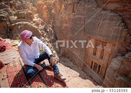 Asian man traveler sitting in Petra, Jordan Asian man traveler sitting in Petra, Jordan 55116393