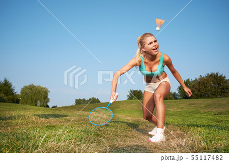 Fitness, young woman playing badminton in a city Fitness, young woman playing badminton in a city 55117482