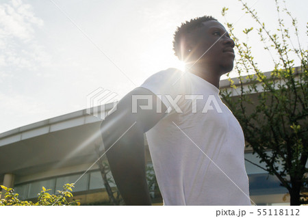 African American man with hands on hips pose looking to the sky at home 55118112