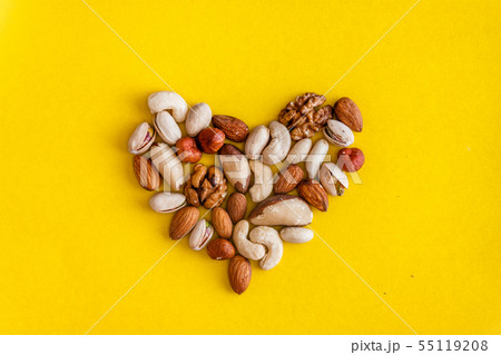 A variety of nuts are laid out in the shape of a A variety of nuts are laid out in the shape of a 55119208