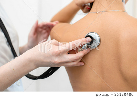 Woman doctor therapist listening with a Woman doctor therapist listening with a 55120486