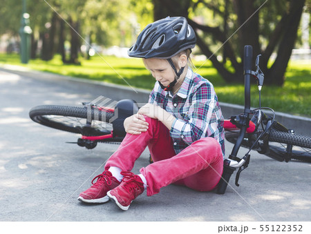 Crying girl is sitting next to her bike 55122352