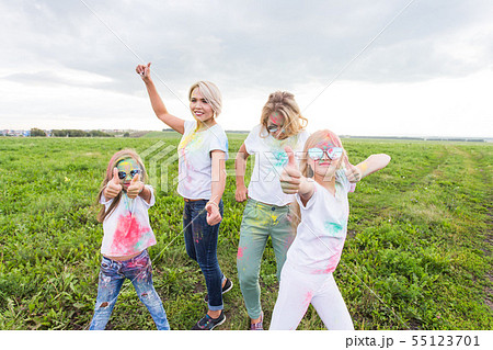 Family, festival of holi and holidays concept - portrait of happy family covered in paint 55123701