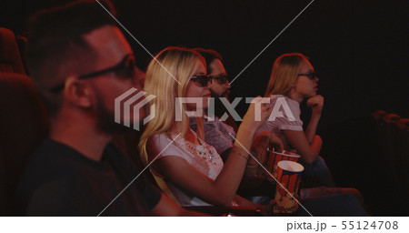 Family eating popcorn in cinema 55124708