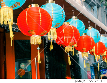 Chinese Paper Lanterns Sway on Wind on the Roof of a Building by Day on the Street 55125316