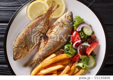 Fried Salema porgy fish with a side dish of fresh Fried Salema porgy fish with a side dish of fresh 55130806