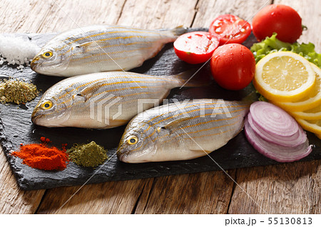 Freshly caught Sarpa salpa with raw vegetables and 55130813