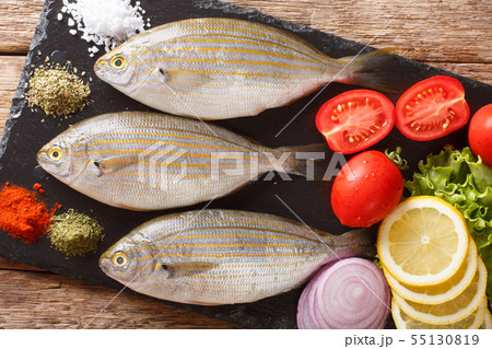 Freshly caught Sarpa salpa with raw vegetables and 55130819