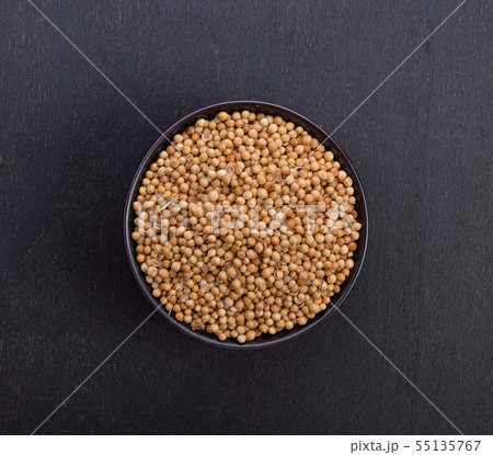 Coriander seeds on black background Coriander seeds on black background 55135767