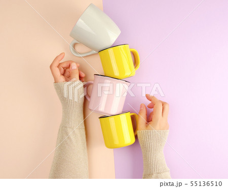 stack ceramic cups are supported by a female hand stack ceramic cups are supported by a female hand 55136510