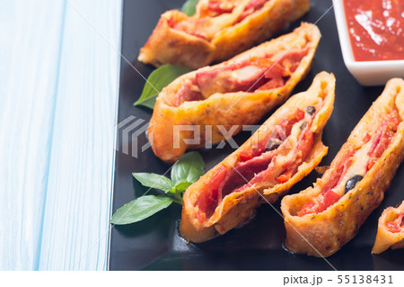 Pizza roll stromboli with cheese salami olives and 55138431