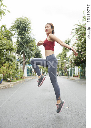 Woman jumping to warm up Woman jumping to warm up 55139777