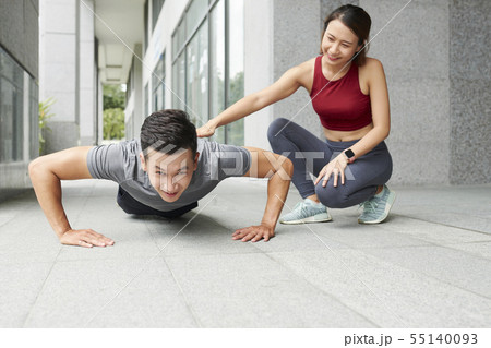 Man doing press-ups under control 55140093