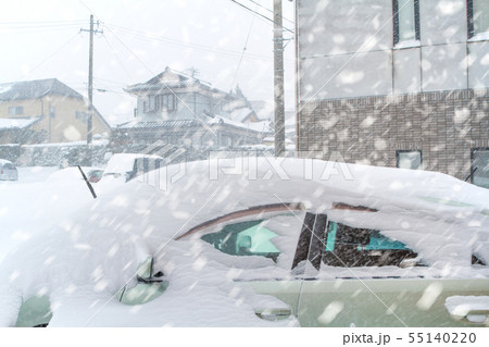 Car covered with snow during snowstorm 55140220
