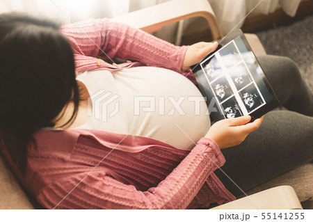 Happy pregnant woman and expecting baby at home. Happy pregnant woman and expecting baby at home. 55141255