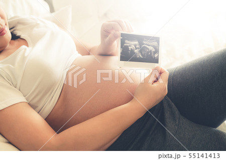 Happy pregnant woman and expecting baby at home. Happy pregnant woman and expecting baby at home. 55141413