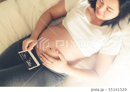Happy pregnant woman and expecting baby at home. 55141520
