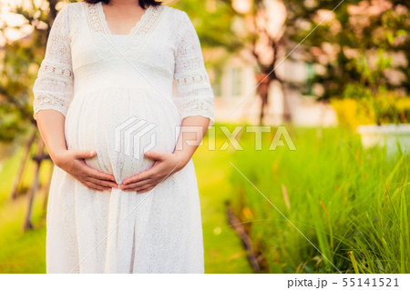 Pregnant woman feeling happy at garden home. 55141521