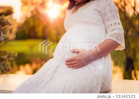 Pregnant woman feeling happy at garden home. Pregnant woman feeling happy at garden home. 55141525