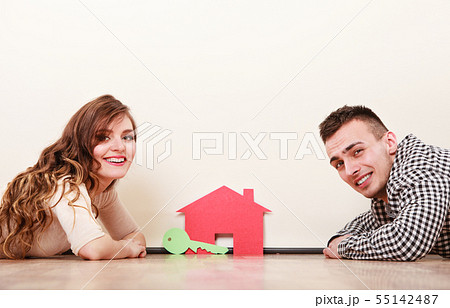 Couple with paper house. Housing real estate. 55142487