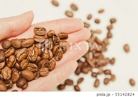 Coffee beans in farmers hand. 55142824