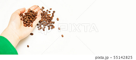 Dark roasted coffee beens in the farmer s hand 55142825