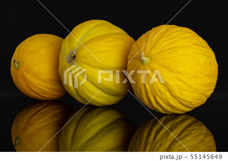 Yellow canary melon isolated on black glass 55145649