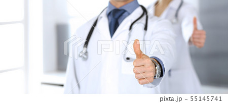 Group of doctors showing thumbs up. Perfect medical service in clinic. Happy future in medicine and 55145741