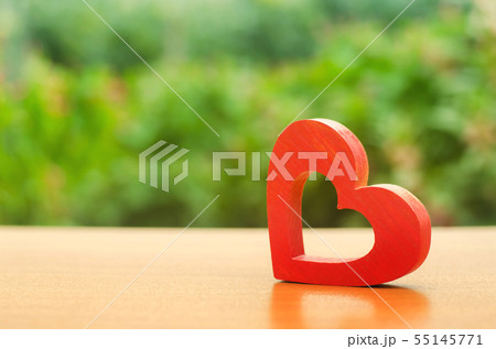 A red wooden heart on nature background A red wooden heart on nature background 55145771