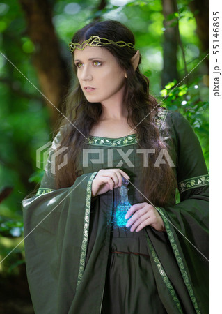 Elf with a bottle of magic potion in the forest Elf with a bottle of magic potion in the forest 55146895