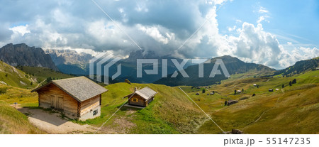 Odle Puez mountain and wooden chalets in Dolomites, Trentino Alto Adige, Italy Odle Puez mountain and wooden chalets in Dolomites, Trentino Alto Adige, Italy 55147235