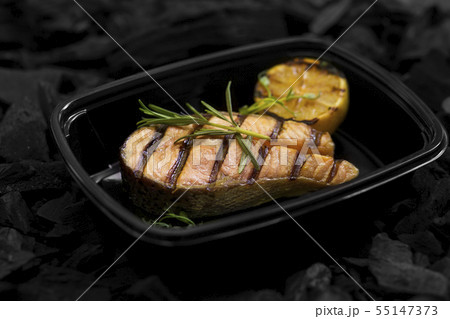 Close up of fresh cooked fish with rosemary in box Close up of fresh cooked fish with rosemary in box 55147373