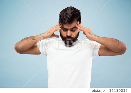 Half-length close up portrait of young man on blue background. Half-length close up portrait of young man on blue background. 55150035