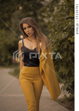 Side view of glamorous brunette posing in smart 55150761