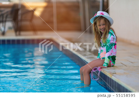 Portrait of cute happy little girl having fun in swimming pool Portrait of cute happy little girl having fun in swimming pool 55158595