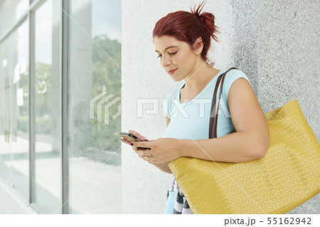 Texting young woman 55162942