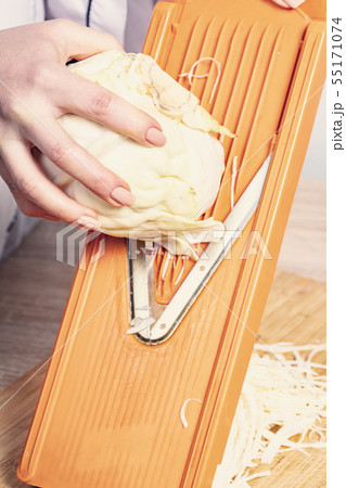 sliced cabbage on shredder 55171074