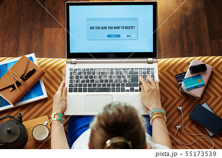 stylish housewife deleting software on laptop stylish housewife deleting software on laptop 55173539